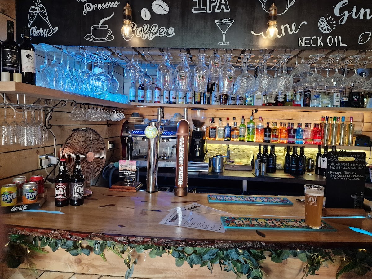 The Naughty Habit bar with draught taps, spirits and warm timber finishes
